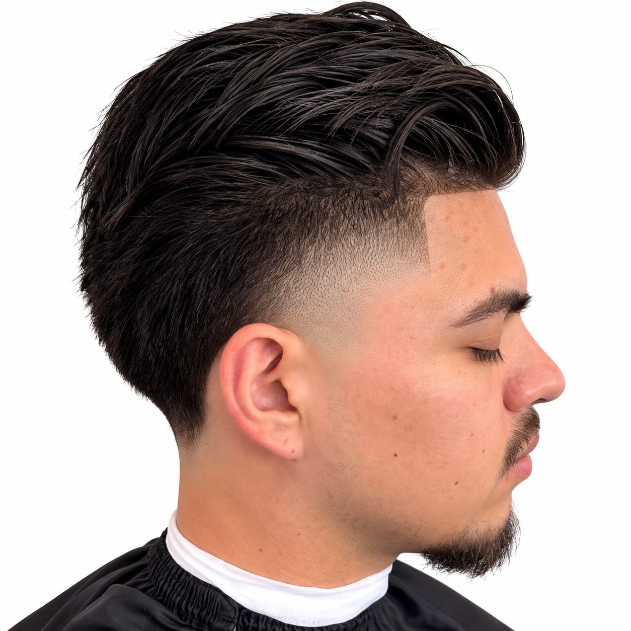 High taper with a swept-back top, line-up and trimmed goatee, right profile