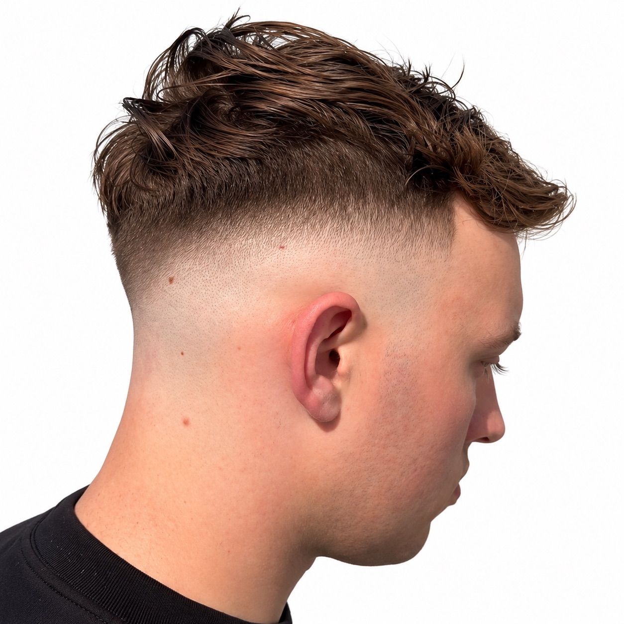 High drop fade with a long, wavy textured top, right profile