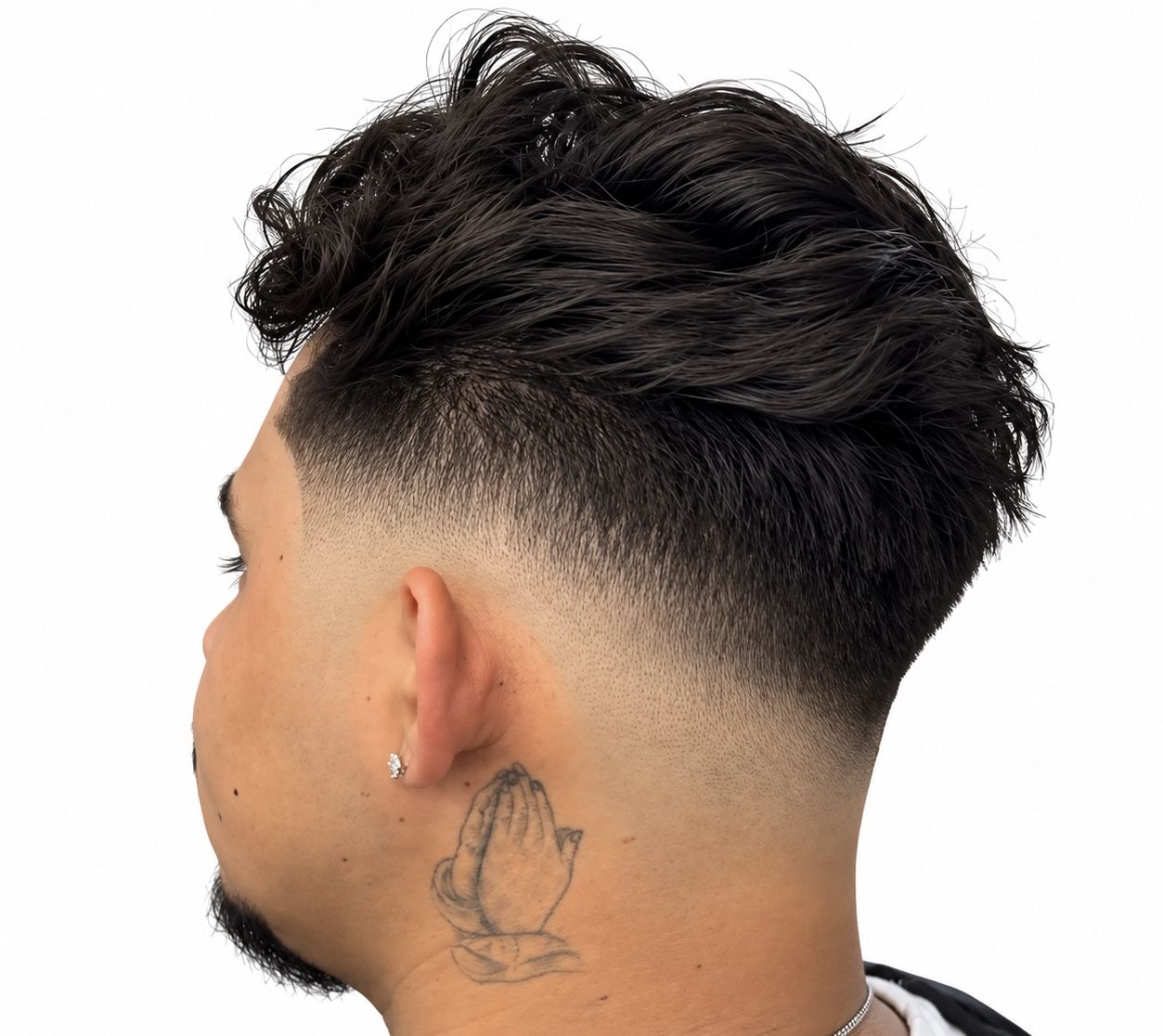 Mid drop fade under a dark wavy top, seen from the rear left