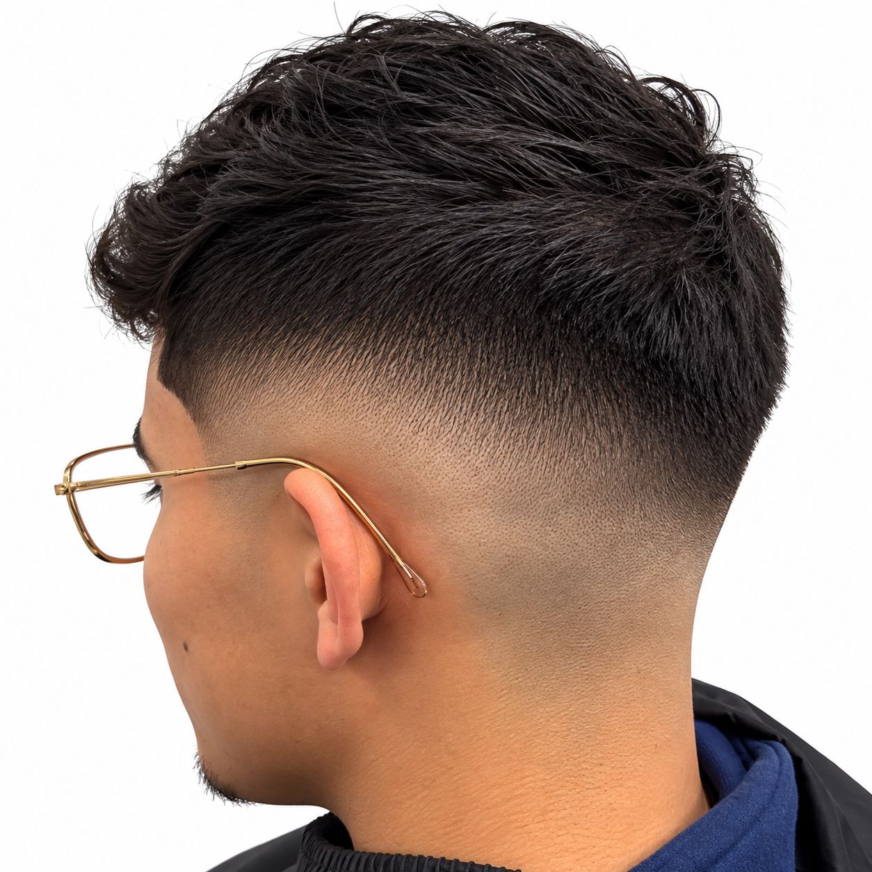 Mid drop fade with a textured top on a client wearing glasses